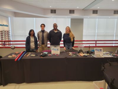 Four PAGSO members stand behind an outreach station